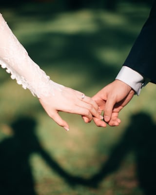 A newly married couple holding hands